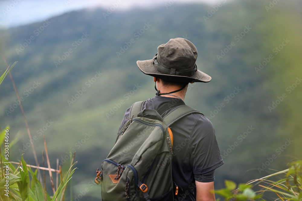 Asian hiking man look view beautiful rainforest mountain landscape, Adventure and trekking concept. Asian hiking man look view beautiful rainforest mountain landscape, Adventure and trekking concept.