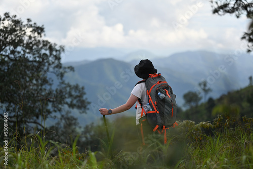 Asian woman hiking look view beautiful rainforest mountain landscape, Adventure and trekking concept.
