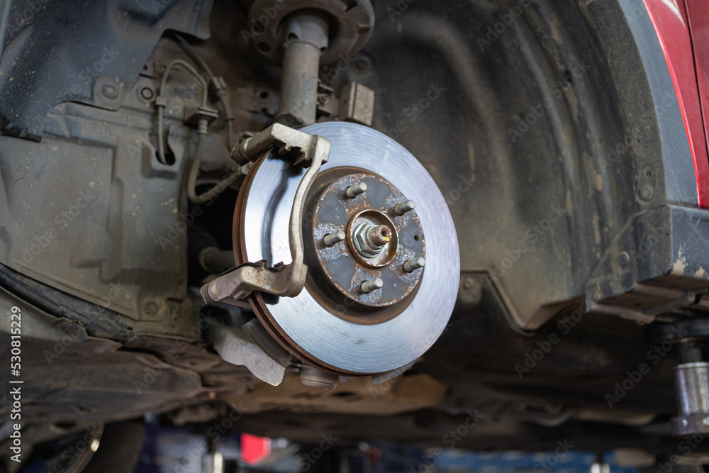 Cars whose wheels have been removed until the brake discs are visible