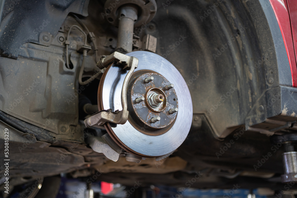 Cars whose wheels have been removed until the brake discs are visible Cars whose wheels have been removed until the brake discs are visible