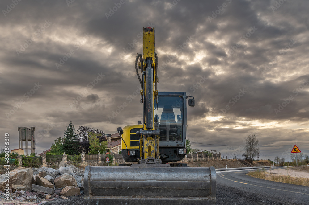 An excavator at road repair works An excavator at road repair works
