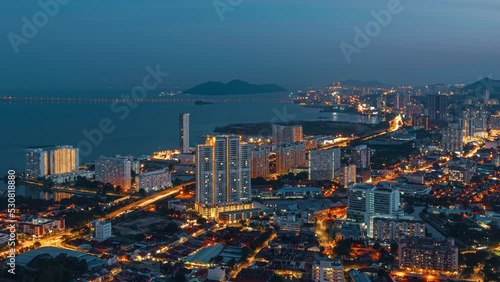 Panoramic view from the skyscraper to the city, bridge and sea bay on the evening in George Town, Penang, Malaysia. 4K time-lapse. photo