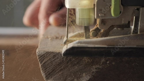 woodworker cutting wood with jigsaw