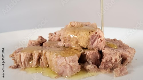 Tuna fish - Pouring olive oil on tuna fish