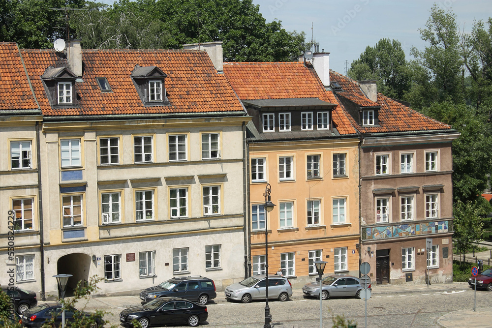 European architecture style of buildings in the street. Red tiled roof and brick buildings
