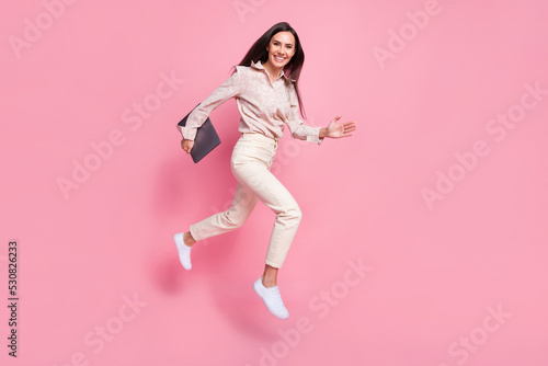 Full length photo of marketer lady jump hurry for digital web discounts isolated on pastel color background
