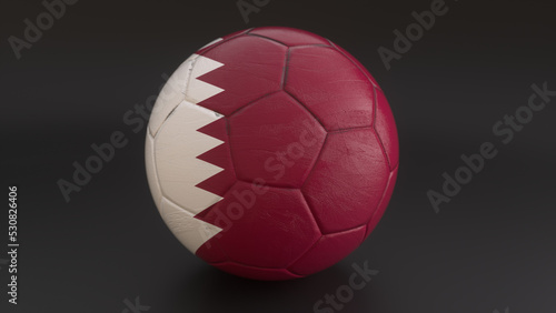 Drapeau du Qatarincrust   dans un ballon de football