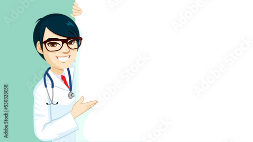 Happy male professional doctor wearing glasses and stethoscope presenting blank billboard