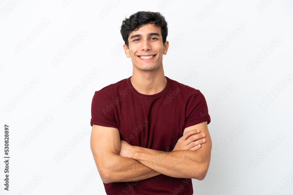 Young Argentinian man isolated on white background keeping the arms crossed in frontal position Young Argentinian man isolated on white background keeping the arms crossed in frontal position