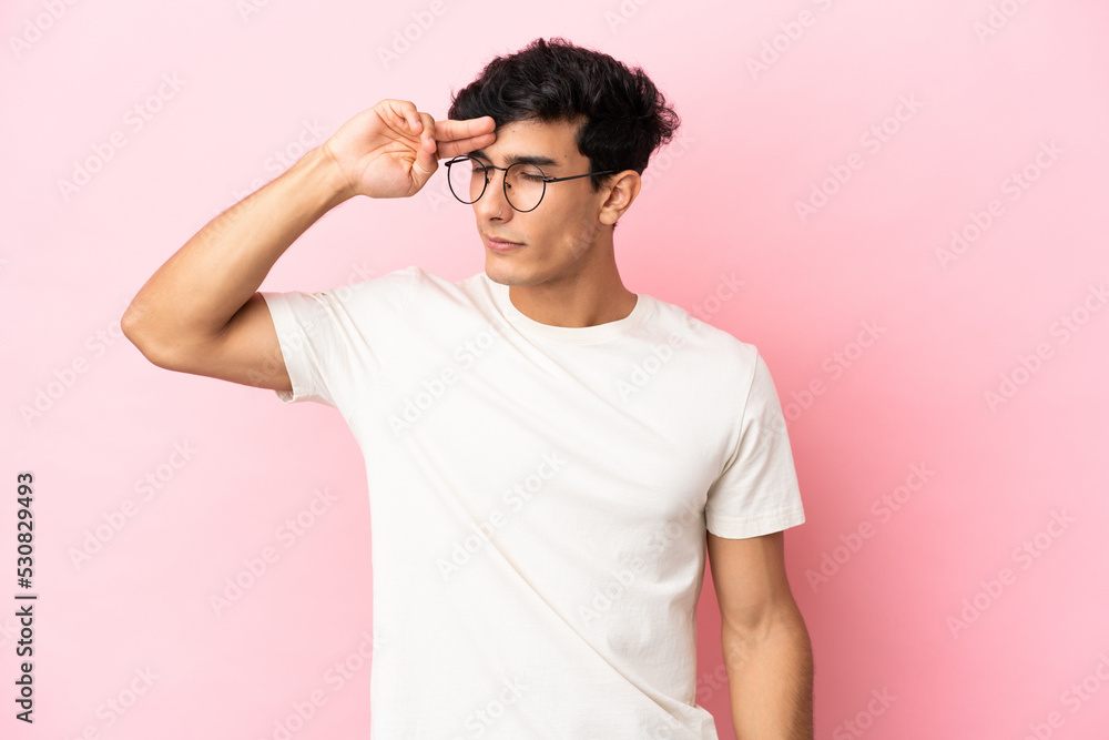 Young Argentinian man isolated on pink background with tired and sick expression Young Argentinian man isolated on pink background with tired and sick expression