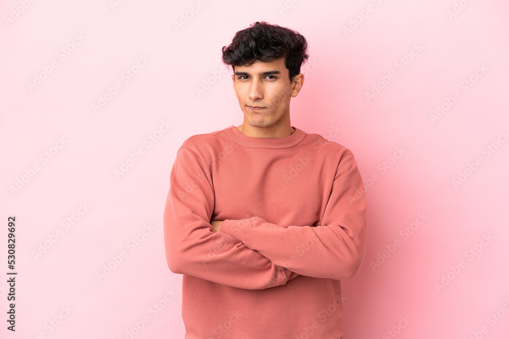 Young Argentinian man isolated on pink background with unhappy expression Young Argentinian man isolated on pink background with unhappy expression