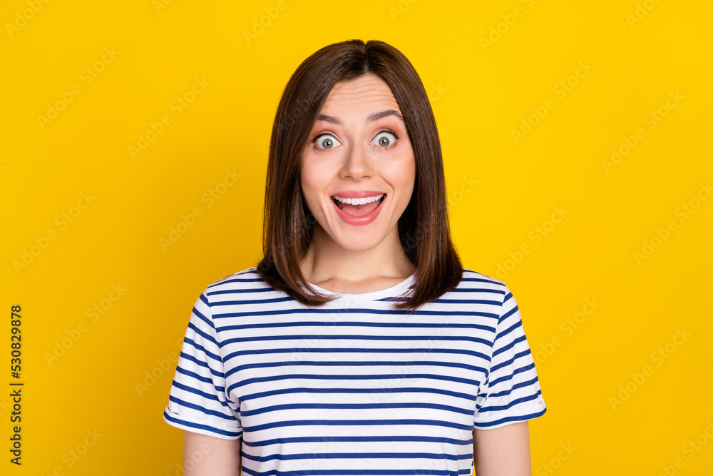 Portrait of pretty gorgeous adorable woman dressed striped t-shirt staring at unbelievable sale isolated on yellow color background Portrait of pretty gorgeous adorable woman dressed striped t-shirt staring at unbelievable sale isolated on yellow color background