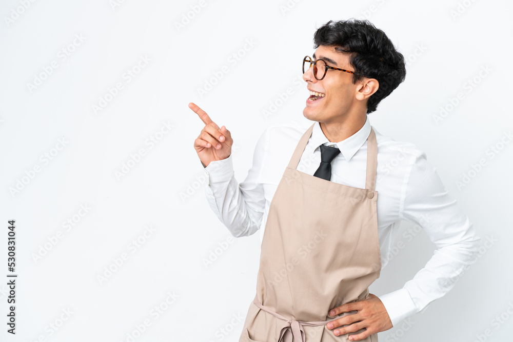 Restaurant Argentinian waiter isolated on white background pointing finger to the side and presenting a product Restaurant Argentinian waiter isolated on white background pointing finger to the side and presenting a product