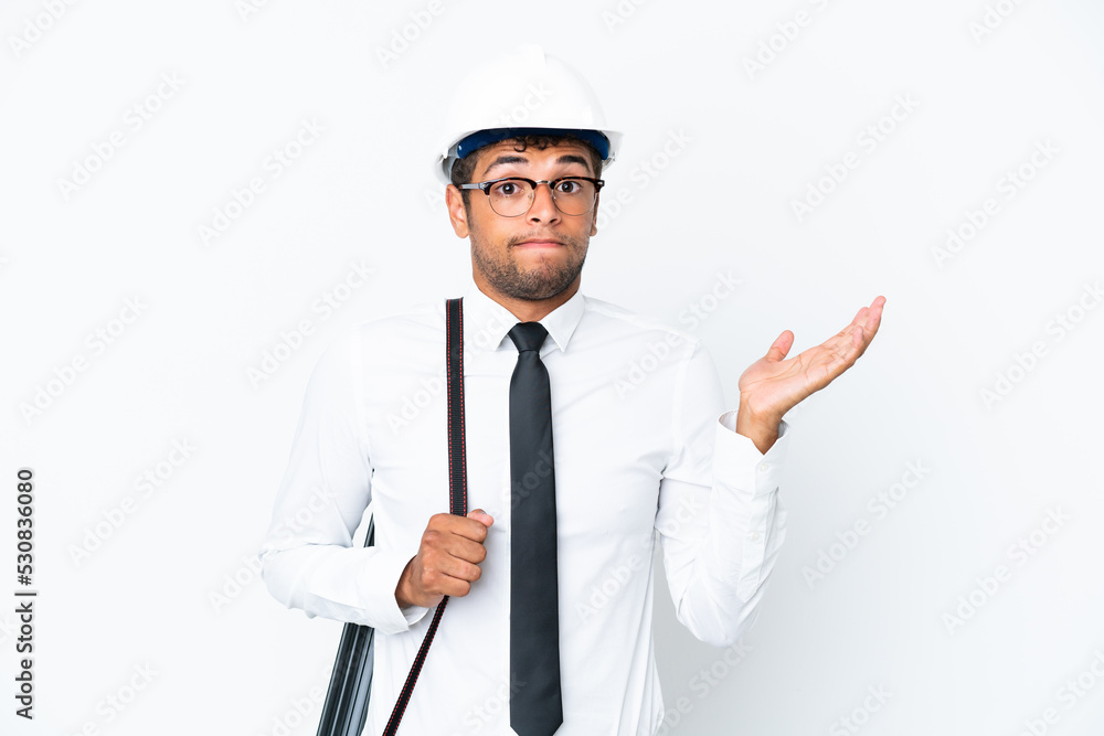 Architect brazilian man with helmet and holding blueprints having doubts while raising hands Architect brazilian man with helmet and holding blueprints having doubts while raising hands