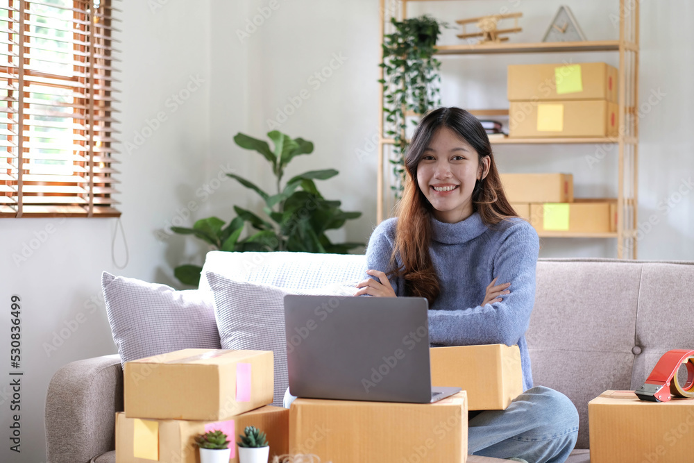 Startup SME small business entrepreneur of freelance asian woman using a laptop with box Cheerful success online marketing packaging box and delivery SME idea concept. Startup SME small business entrepreneur of freelance asian woman using a laptop with box Cheerful success online marketing packaging box and delivery SME idea concept.