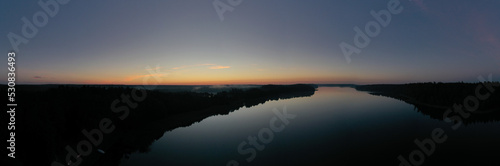 Sunrise over a lake panorama from a drone