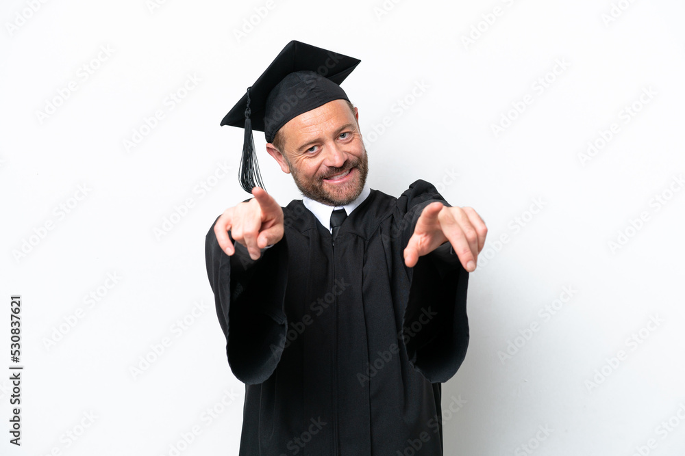 Middle age university graduate man isolated on white background points finger at you while smiling Middle age university graduate man isolated on white background points finger at you while smiling