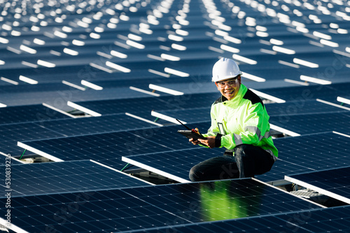 The portrait of a asian young engineer checks photovoltaic solar panels. Concept. renewable energy technology electricity service, green power.