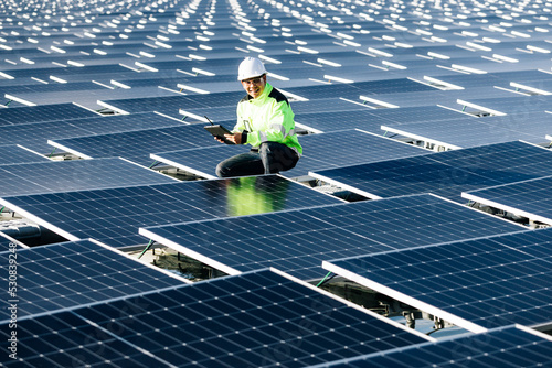 The portrait of a asian young engineer checks photovoltaic solar panels. Concept. renewable energy technology electricity service, green power.