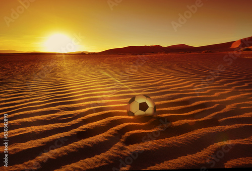 Soccer Ball on Qatar desert by sunrise