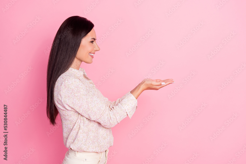 Profile side photo of positive lady promoter showing ads empty space isolated on pastel color background Profile side photo of positive lady promoter showing ads empty space isolated on pastel color background