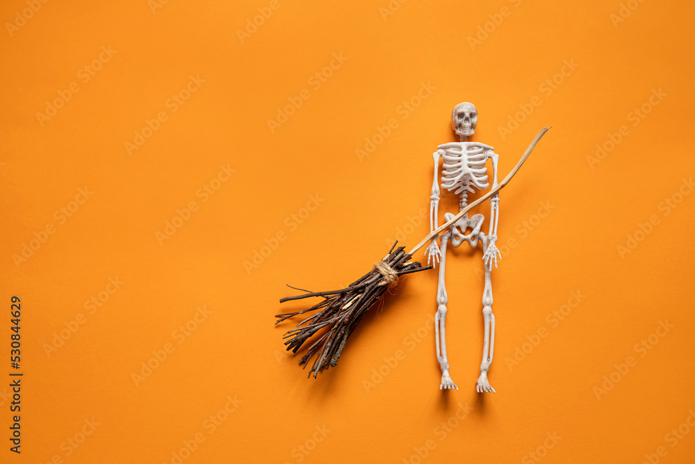 a skeleton with a witch's broom on an orange background , a happy Halloween concept