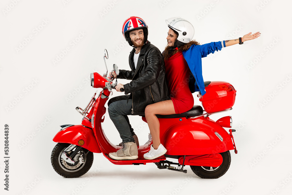 young attractive couple riding an electric motorbike scooter happy having fun together