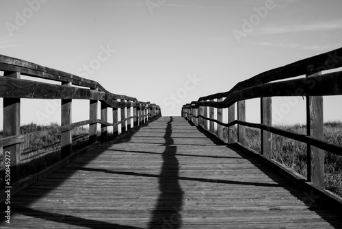 Black and white wooden footbridge to infinity