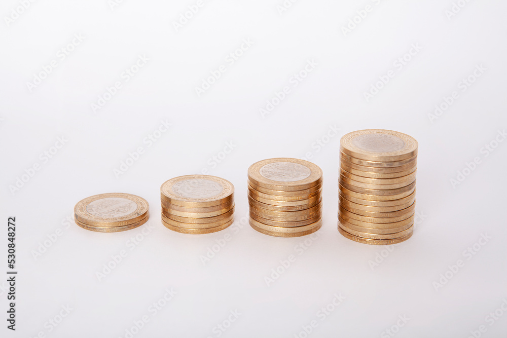 Close-up of coins stack on white background. Close-up of coins stack on white background.