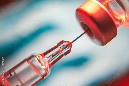 Medical hand glove blue molding vial vaccine hypodermic needle syringe injection treatment.Lab since test immunization and vaccination concept.