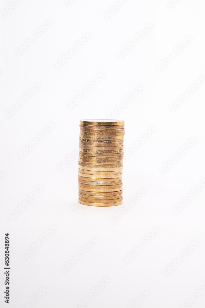 Close-up of coins stack on white background. Close-up of coins stack on white background.