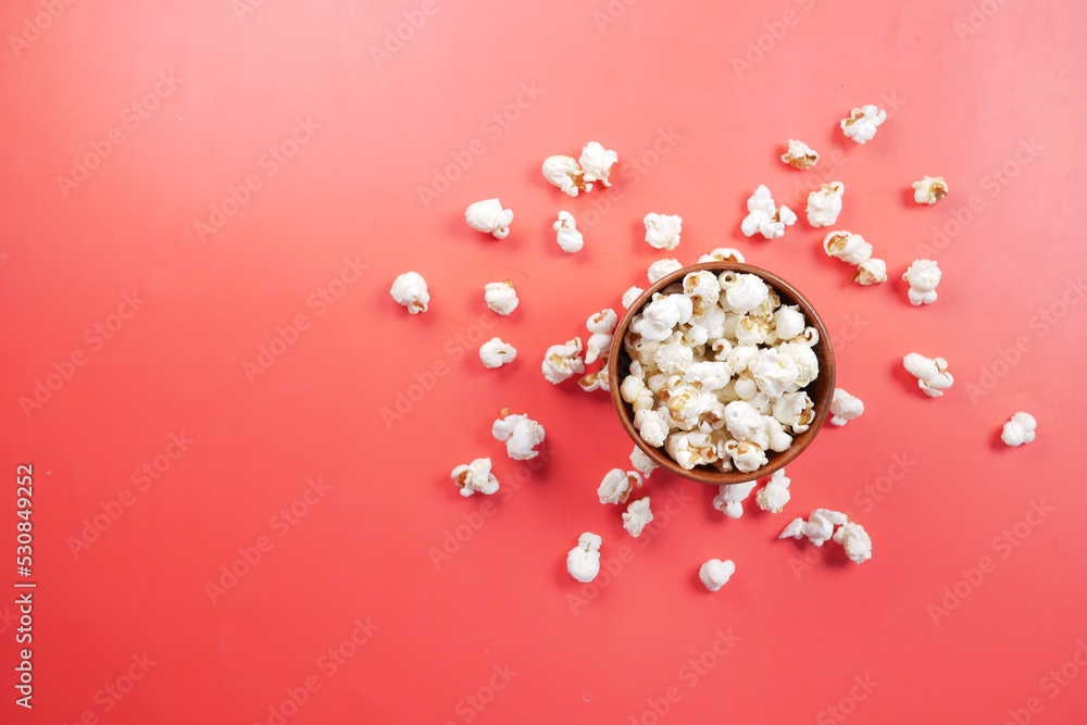 popcorn in a bowl on red background top view popcorn in a bowl on red background top view