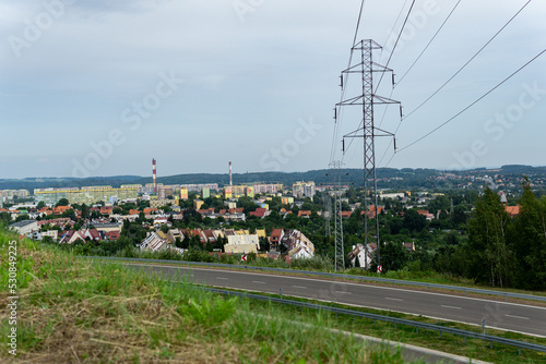 european city district, piaskowa góra wałbrzych, city panorama with a road in front adn energy pole, empty freeway with a city in a background, ring road in wałbrzych,