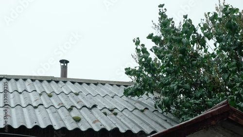 Raindrops fall on the roof of an old building. Autumn rainfall