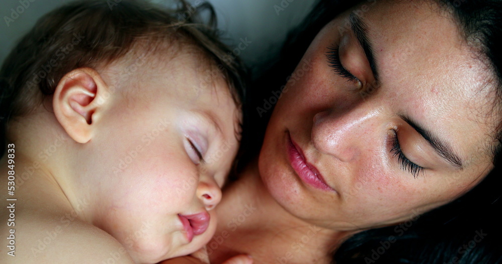 Mother and baby sleeping napping together. Casual mom and infant child asleep nap Mother and baby sleeping napping together. Casual mom and infant child asleep nap