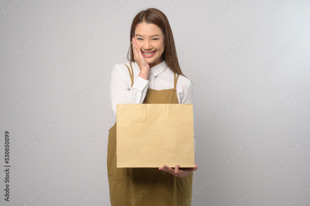 Portrait of young asian woman wearing apron over white background studio, cooking and entrepreneur concept Portrait of young asian woman wearing apron over white background studio, cooking and entrepreneur concept