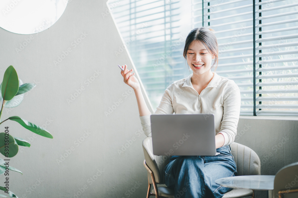 Attractive and happy young female Asian student studying online, sitting at desk, using laptop computer, having video chat, waving, education concept. Attractive and happy young female Asian student studying online, sitting at desk, using laptop computer, having video chat, waving, education concept.