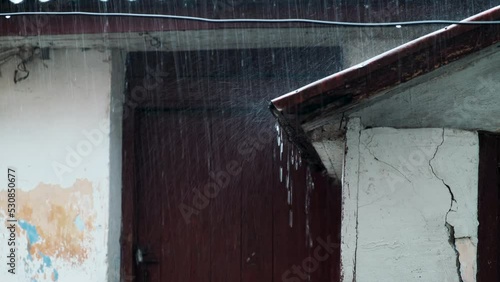 Raindrops fall on the roof of an old building. Autumn rainfall