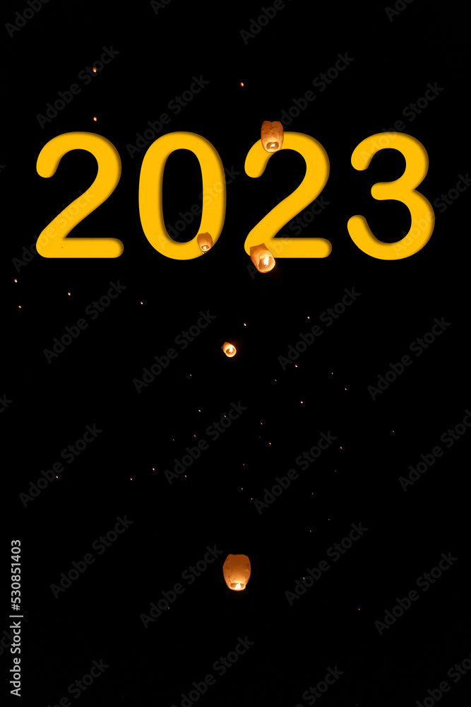 Number 2023 with the background of lanterns in a night sky. New year concept Number 2023 with the background of lanterns in a night sky. New year concept
