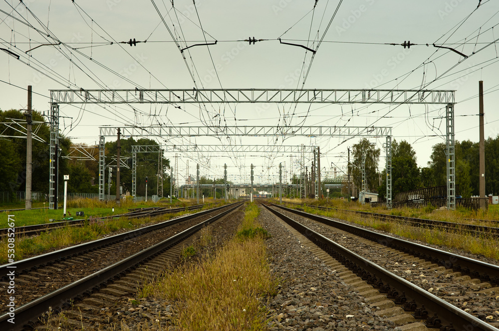 railway, in the photo straight lines of railway tracks against a gray sky railway, in the photo straight lines of railway tracks against a gray sky