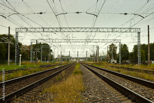 railway, in the photo straight lines of railway tracks against a gray sky