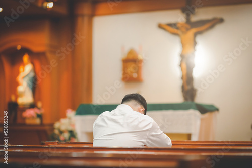 Asian man beard wearing whith shirt christian sitting in church
