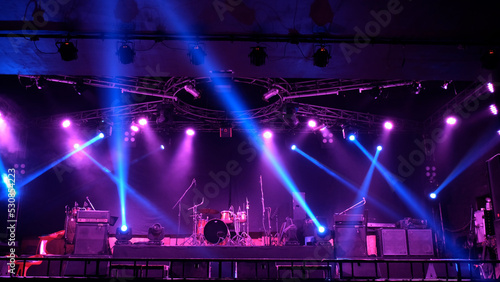 Stage lighting beams spotlight and smoke of events show or concerts
