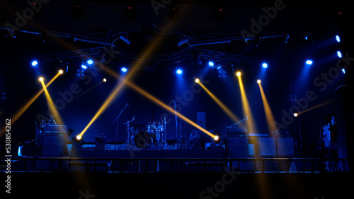 Stage lighting beams spotlight and smoke of events show or concerts