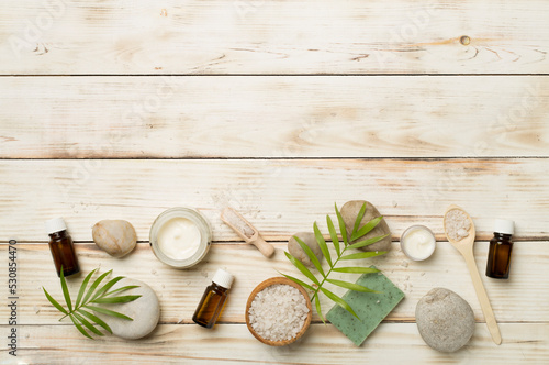 Composition with spa products on wooden background, top view