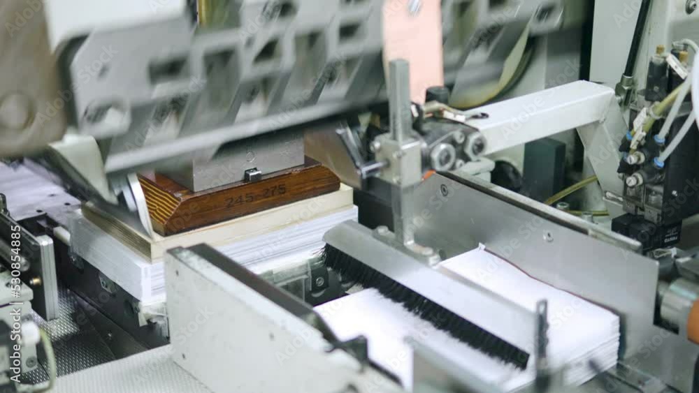 After the books are printed, the pages are formatted with a paper cutting machine and prepared for publication After the books are printed, the pages are formatted with a paper cutting machine and prepared for publication
