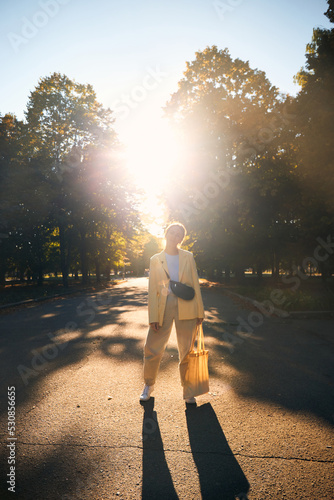 Authentic portrait of eastern european millennial female in autumn park during sunset