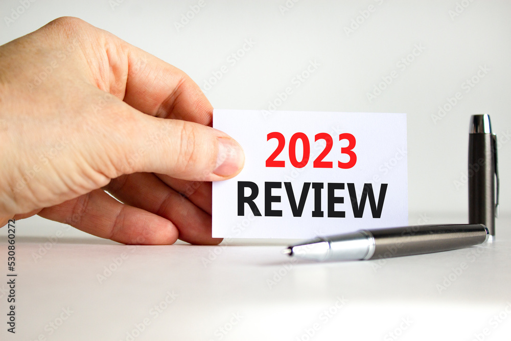 2023 Review symbol. White paper with words 2023 Review. Businessman ...