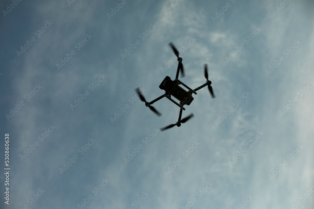 Drone in sky. Quadro copter flies in air. Surveillance from height. Four propellers. Drone in sky. Quadro copter flies in air. Surveillance from height. Four propellers.