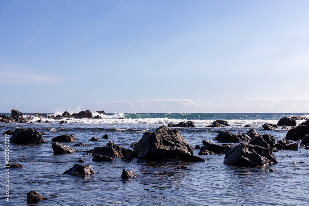 Panoramic sea view from beach Playa Charco del Conde in Valle Gran Rey, La Gomera, Canary Islands, Spain, Europe. Beautiful shoreline of Atlantic Ocean, waves hitting rock formations. Vacation concept